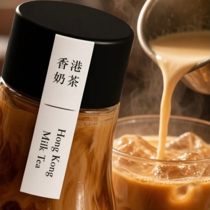 A glass bottle of Hong Kong Milk Tea with a black lid and a white vertical label featuring Chinese and English text, shown next to a glass of iced tea with steaming milk being poured in from a metal pitcher.